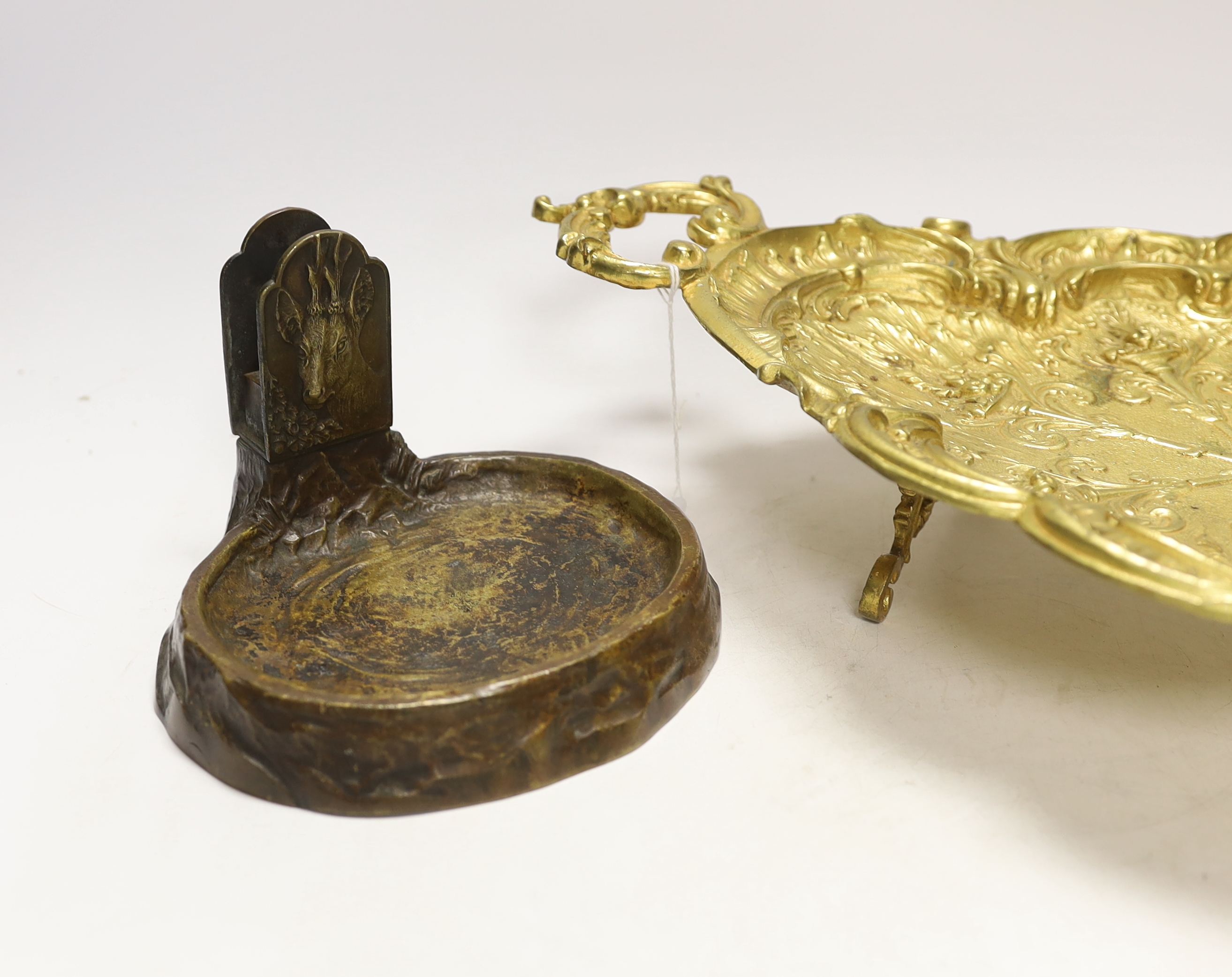 A gilt metal oval dish with twin handles and match tray, 43cm wide
